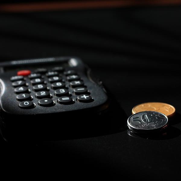 Calculator and coins beside it.