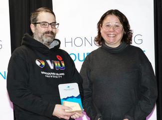 Chris Buechler receives the award for Service Excellence from VIU President Deb Saucier