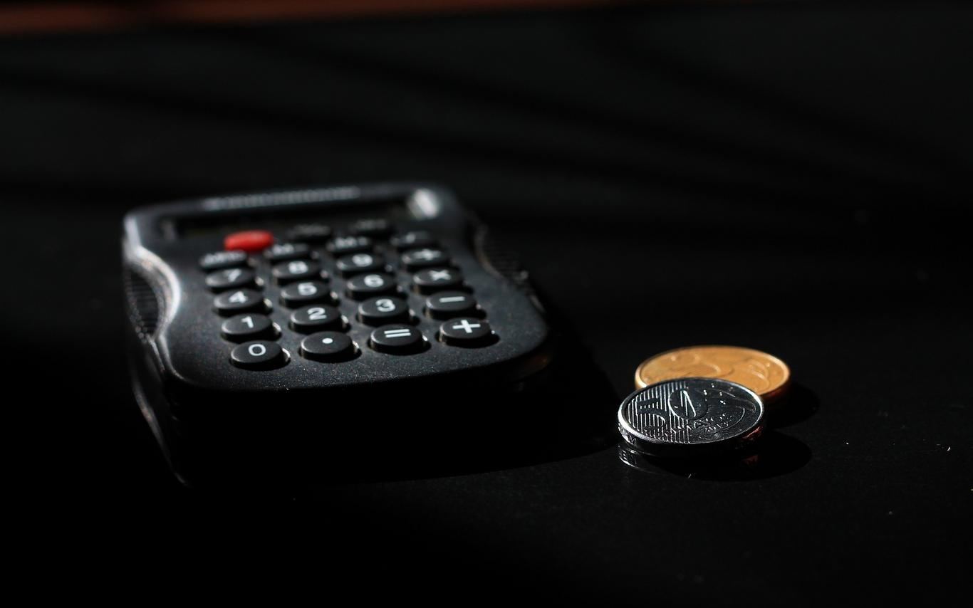 Calculator and coins beside it.